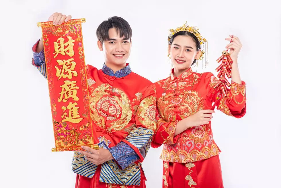 chinese-greeting-card-firecracker-is-used-by-man-woman-wear-cheongsam-suit-celebrate-chinese-new-year-980x654